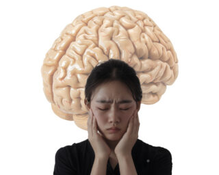 woman with a headache with a brain in the background